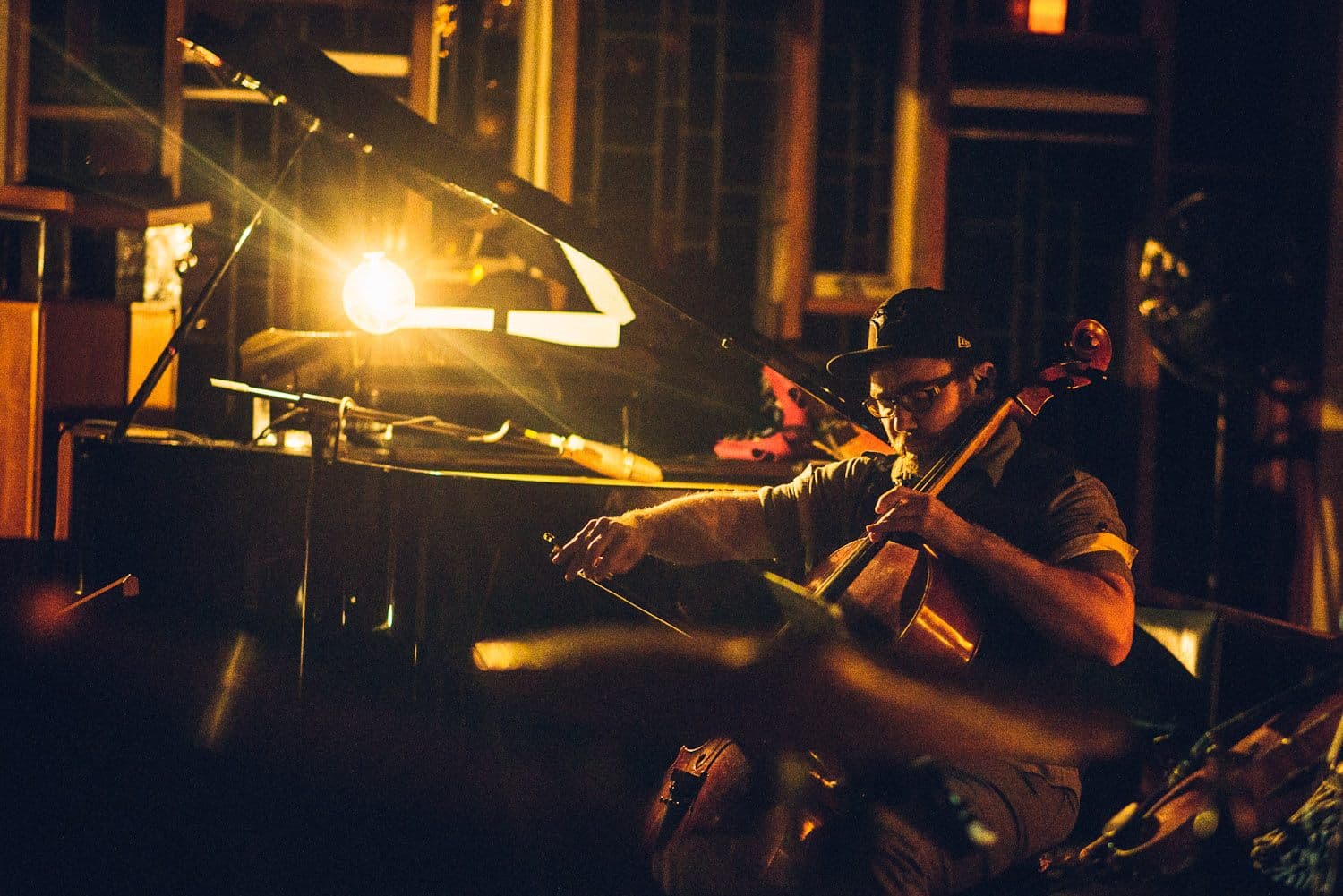 Cello performance with piano in warm stage lighting